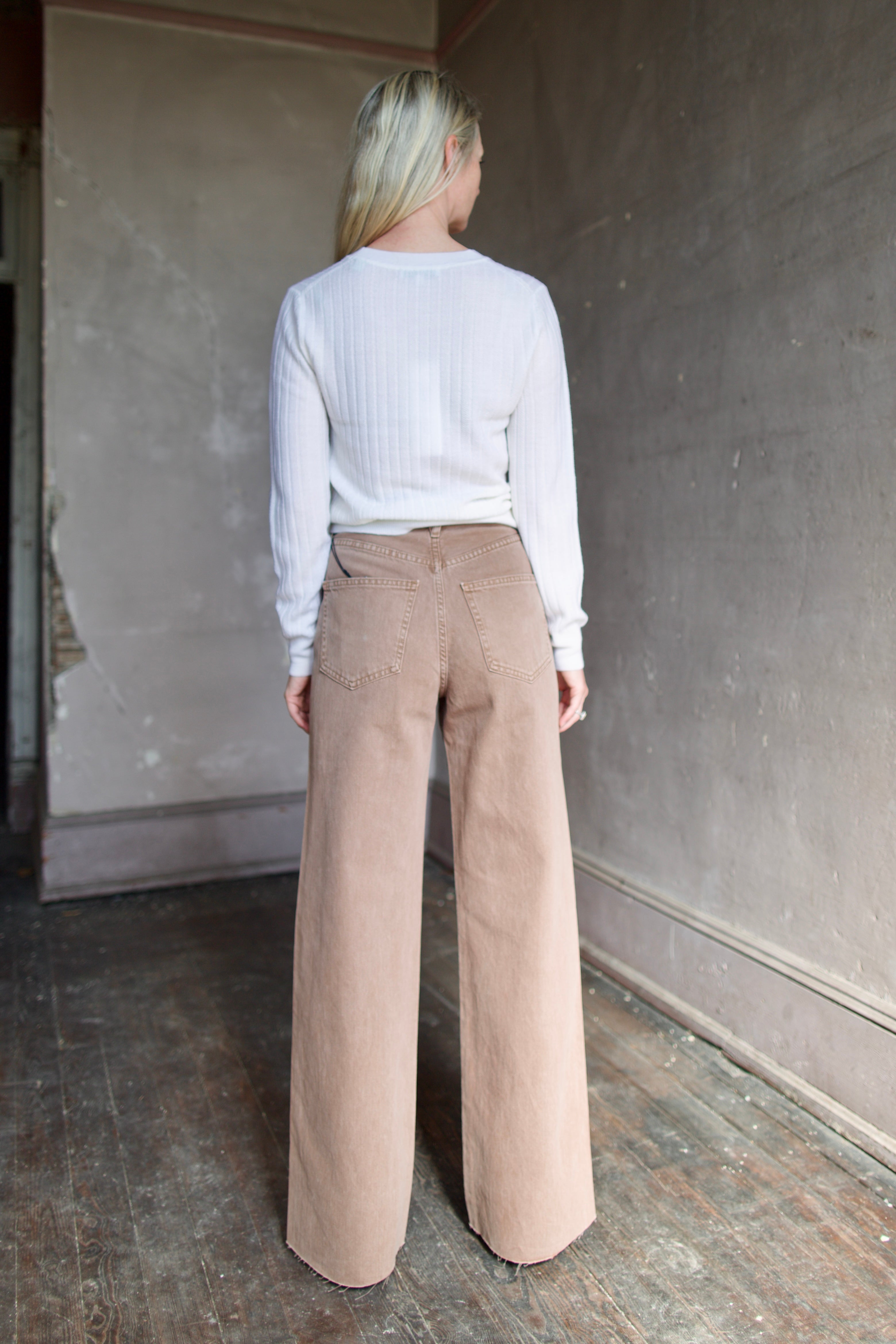 Model wearing a cream wool Cheval pullover and tan Taylor
high rise denim by contemporary designer Veronica Beard