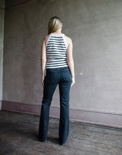 Image featuring a woman wearing the Cameron jeans by Veronica Beard with a high rise and slim bootcut leg in a dark ink wash.