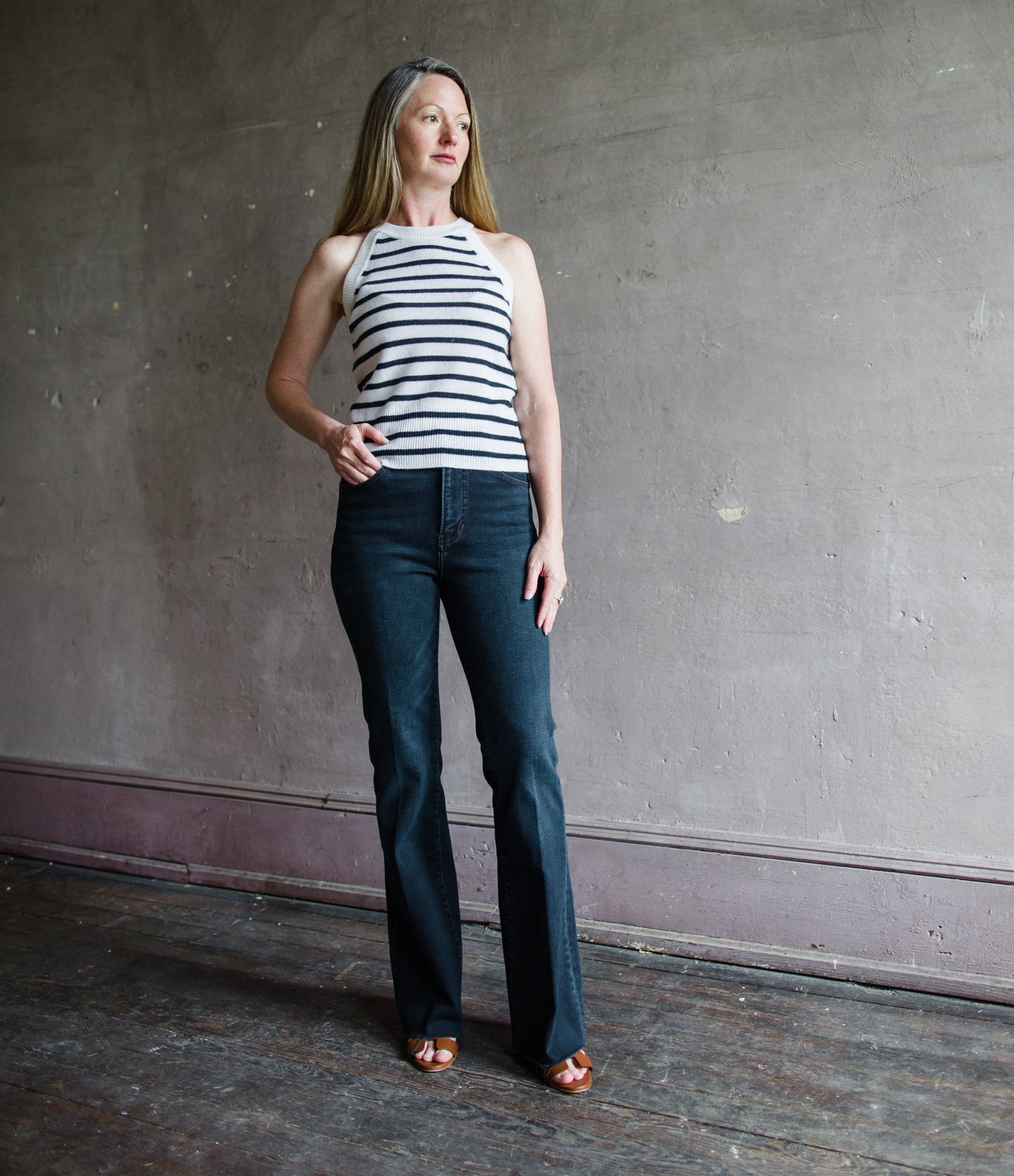 Image featuring a woman wearing the Cameron jeans by Veronica Beard with a high rise and slim bootcut leg in a dark ink wash.