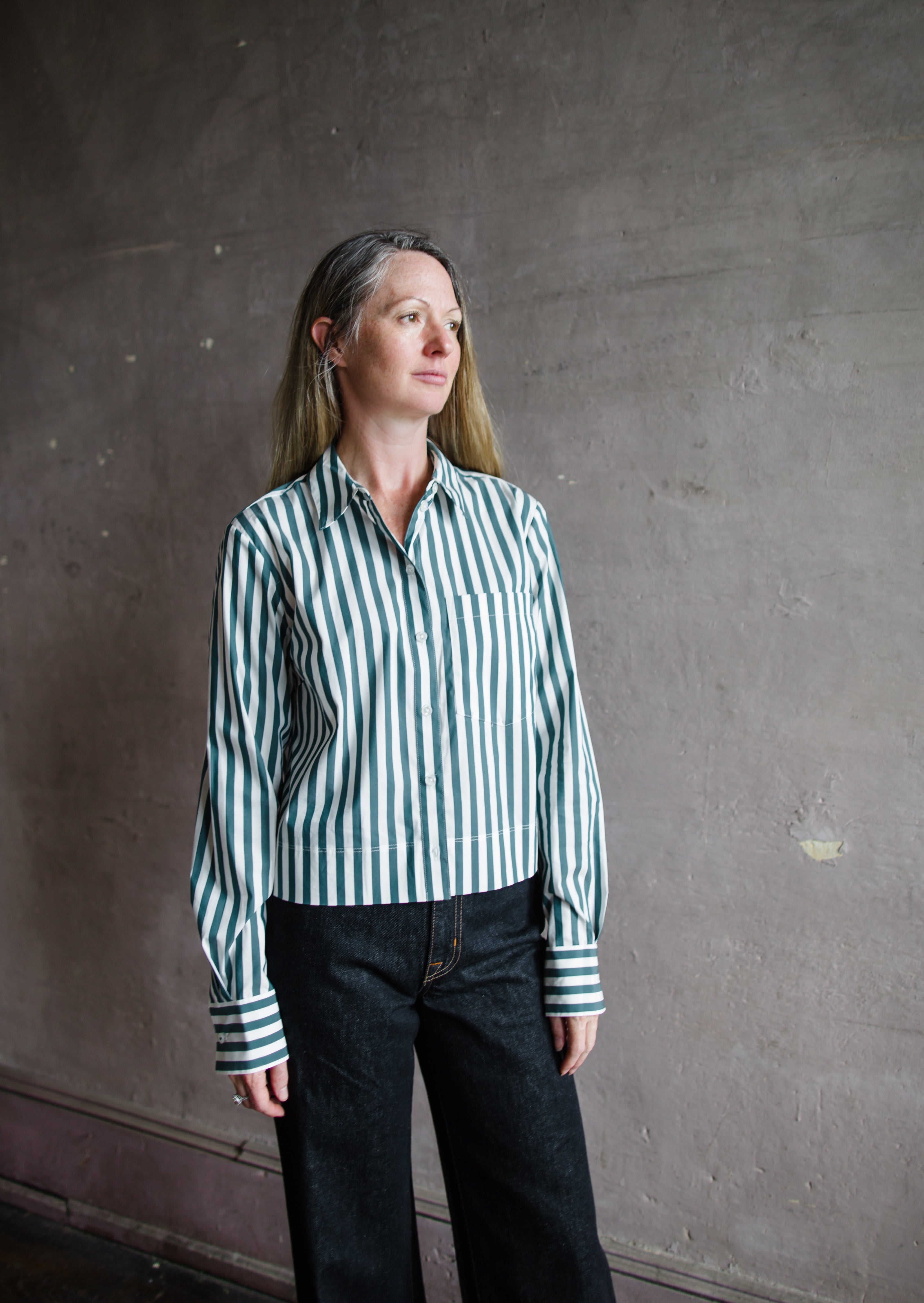 Image featuring a woman wearing he Maia striped top by Veronica Beard features a button front and boxy, slightly cropped fit.