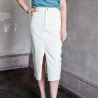 Image featuring a woman wearing  the Breves denim skirt by Veronica Beard in ecru color.