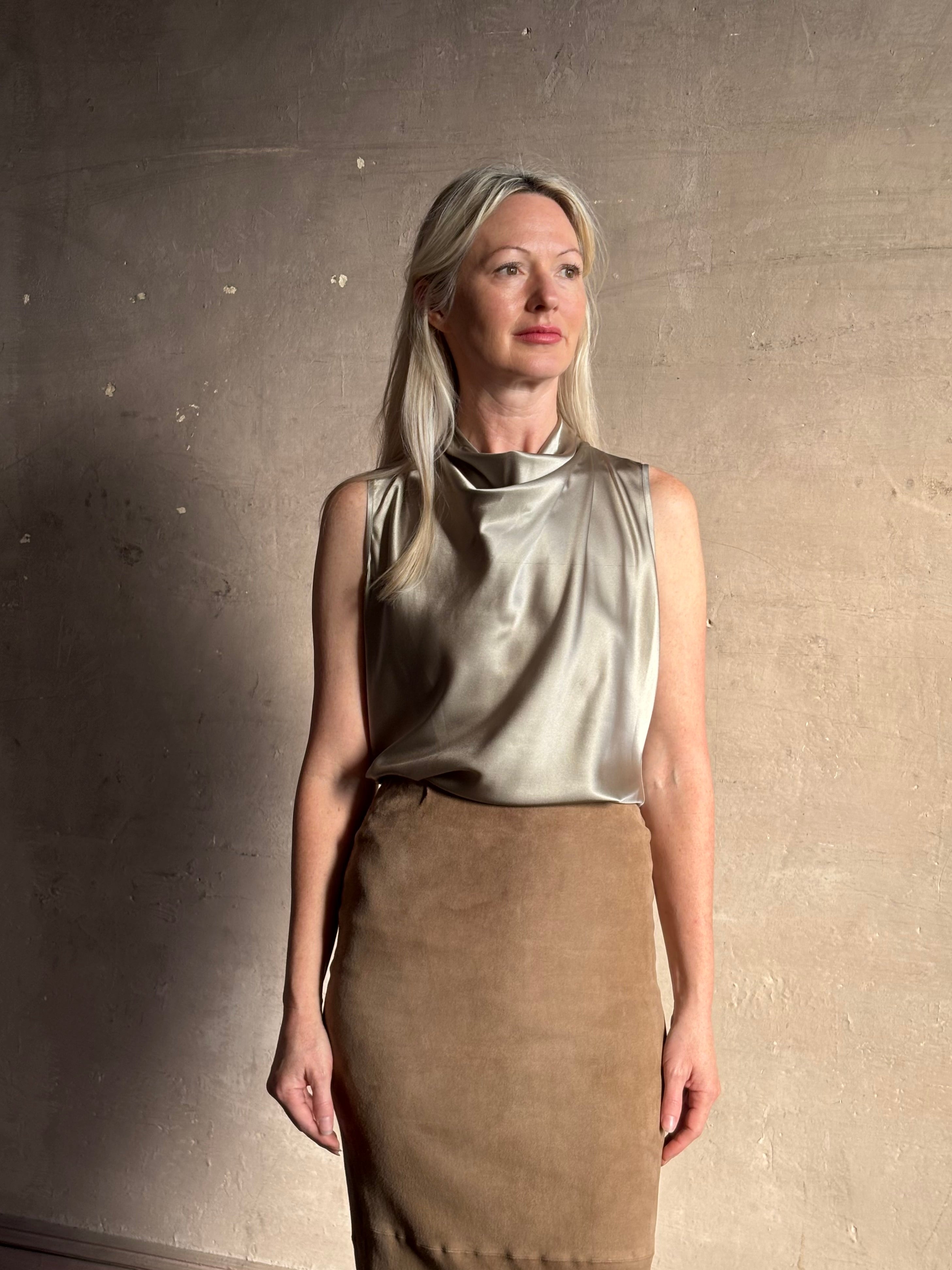 Mature woman wearing Veronica Beard Tam Top in Pewter silk blend waterfall neckline and sleeveless with fluid draping perfect for luxury layering options