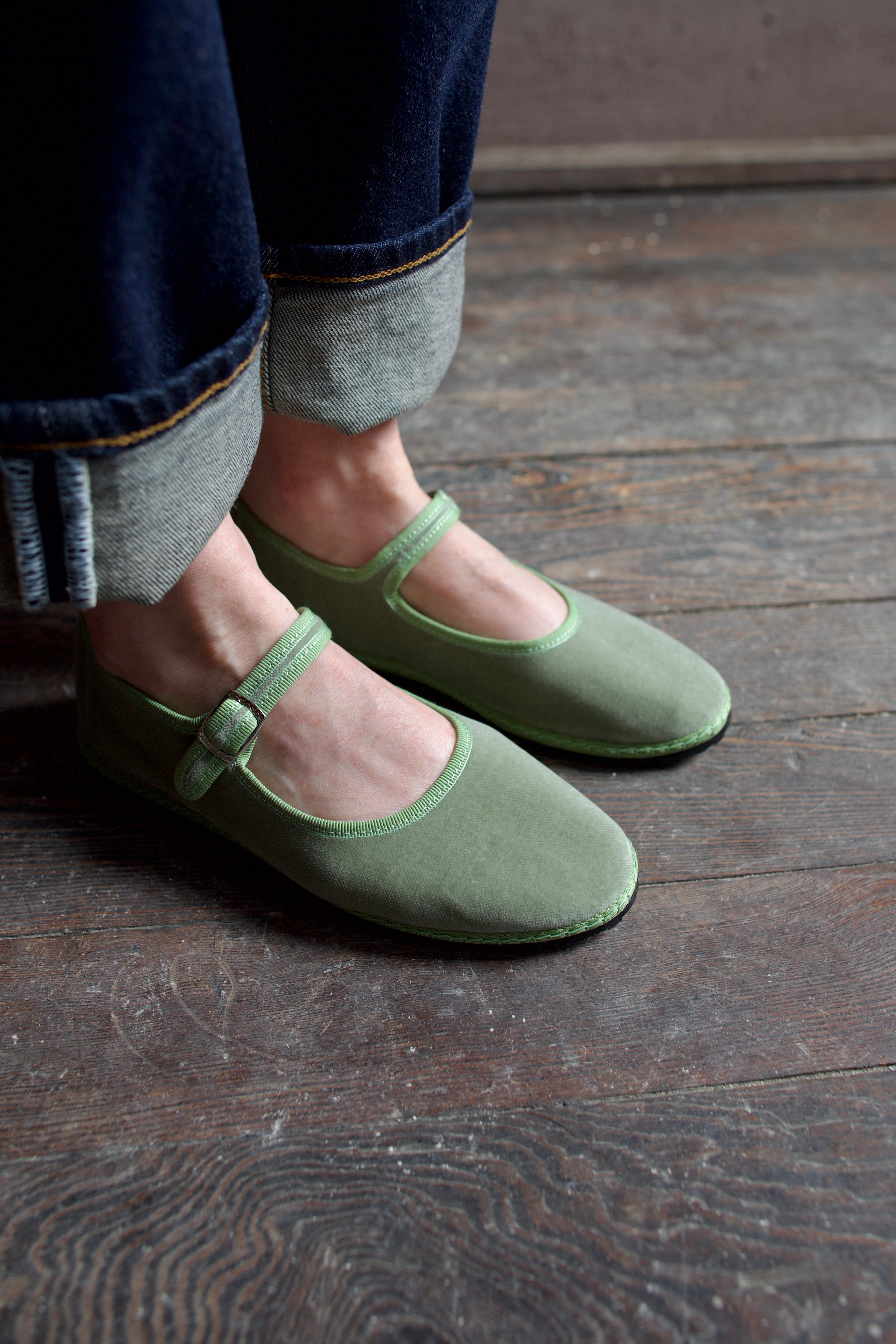 Image of  model wearing Vibi Venezia mint green velvet mary jane's worn with rolled-up jeans 