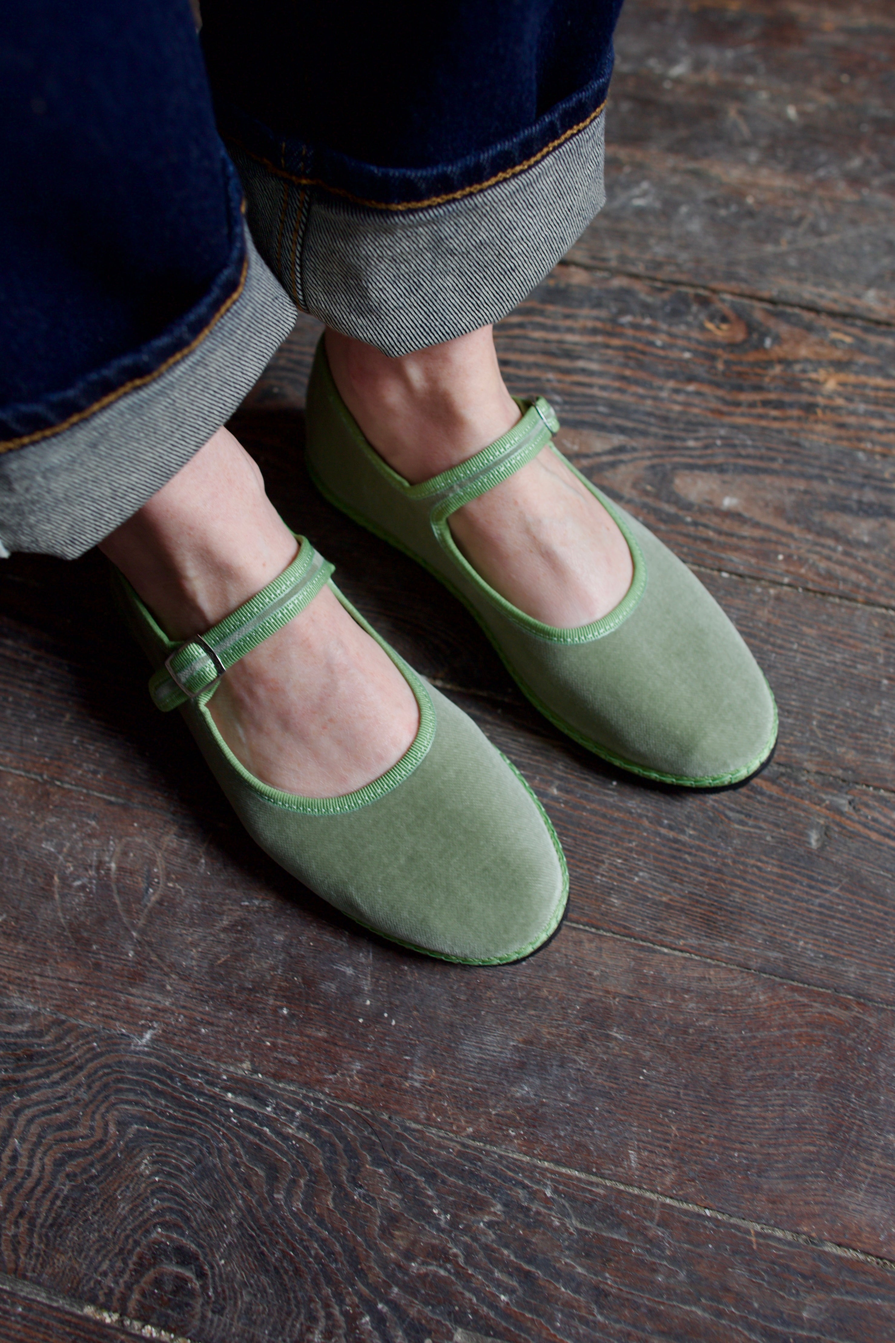 Image of  model wearing Vibi Venezia mint green velvet mary jane's worn with rolled-up jeans 