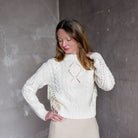 Image featuring a woman wearing the Vince cable-knit sweater is a classic silhouette featuring fringe trim, a crewneck, dropped shoulders, and rib-knit trim.