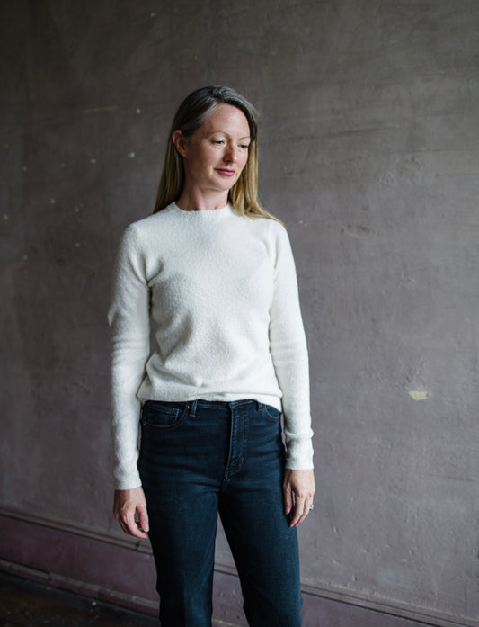 Image featuring a woman wearing the cashmere and silk blend sweater by Vince with a crew neckline, long sleeves and tailored fit in a soft boucle ivory knit.