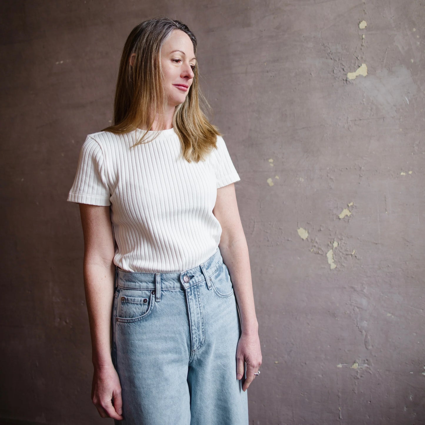 Image featuring a woman wearing a Vince cotton blend short sleeve T-shirt in cream.