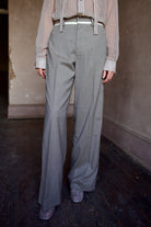 Mature model wearing virgin wool taupe tuxedo trousers with cream details by luxury designer WE-AR4