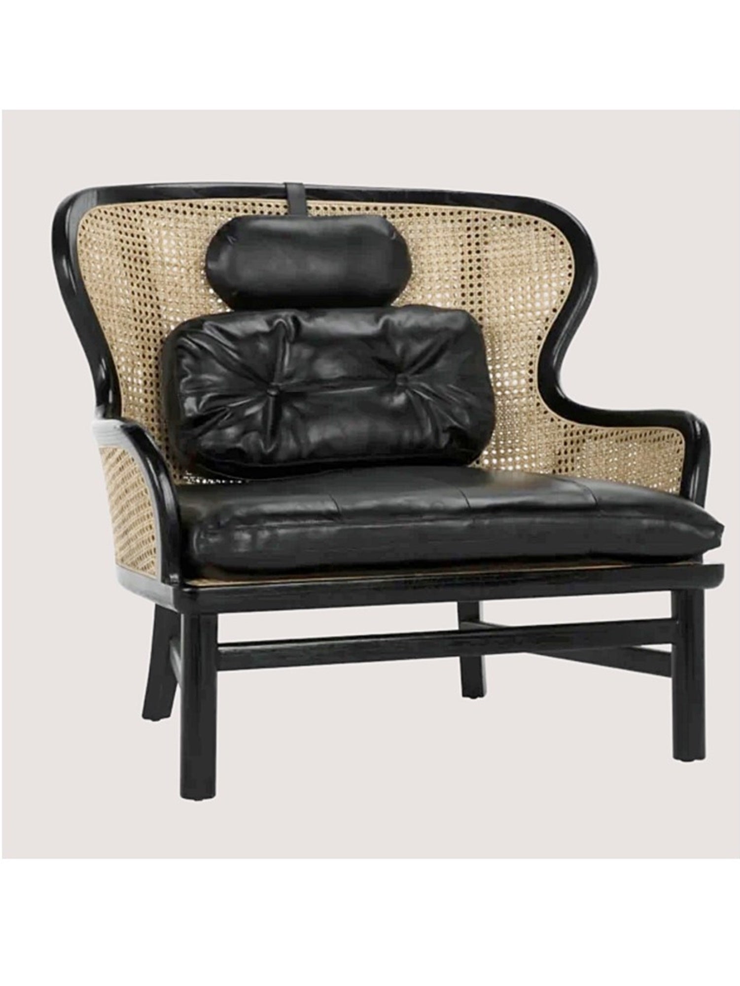 A charcoal black frame wicker and leather chair with a removable black leather seat cushion and pillows.