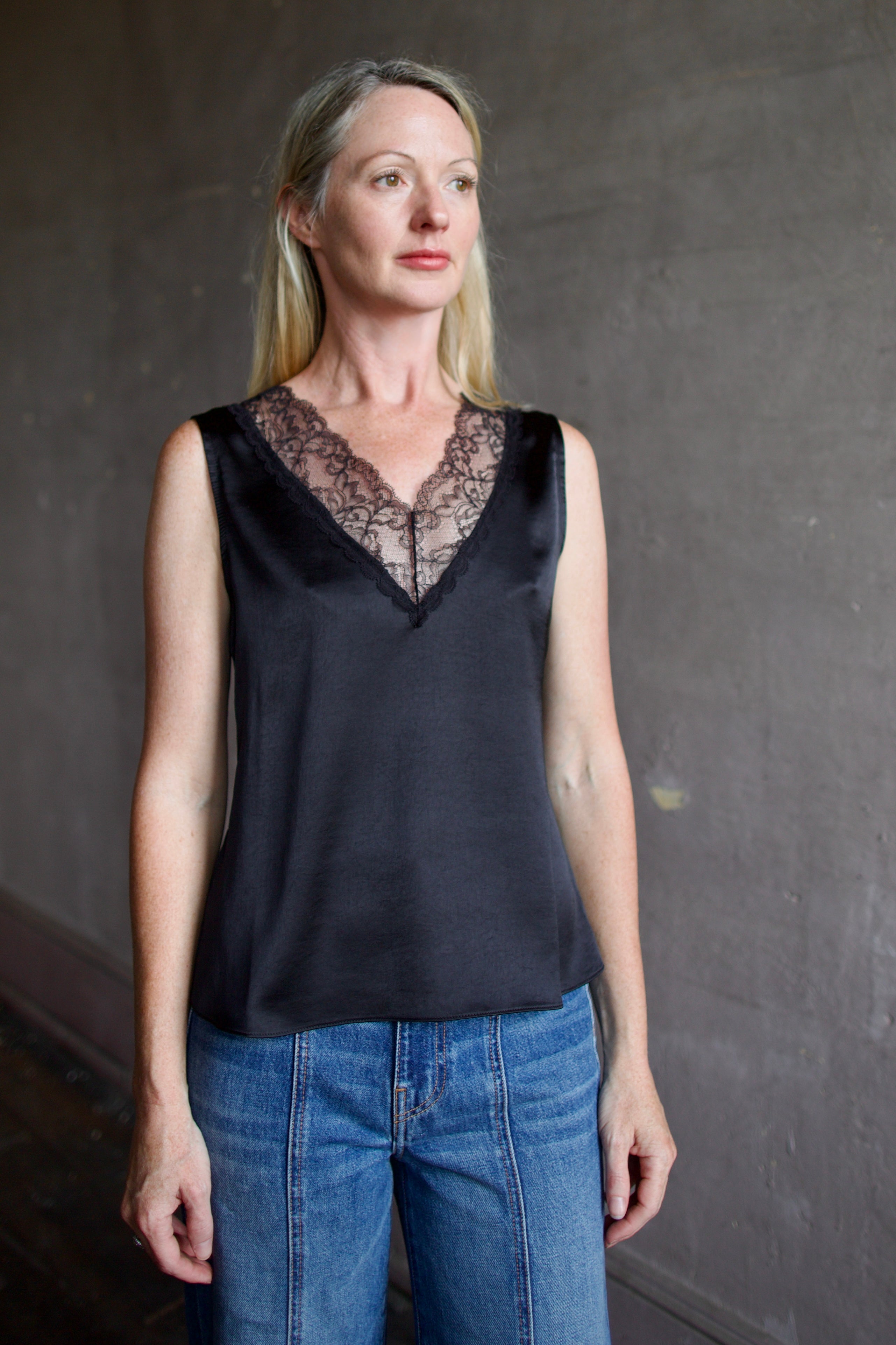 Mature model wearing a bra friendly camisole top with lace detailing at front and back neckline by WE-AR4 