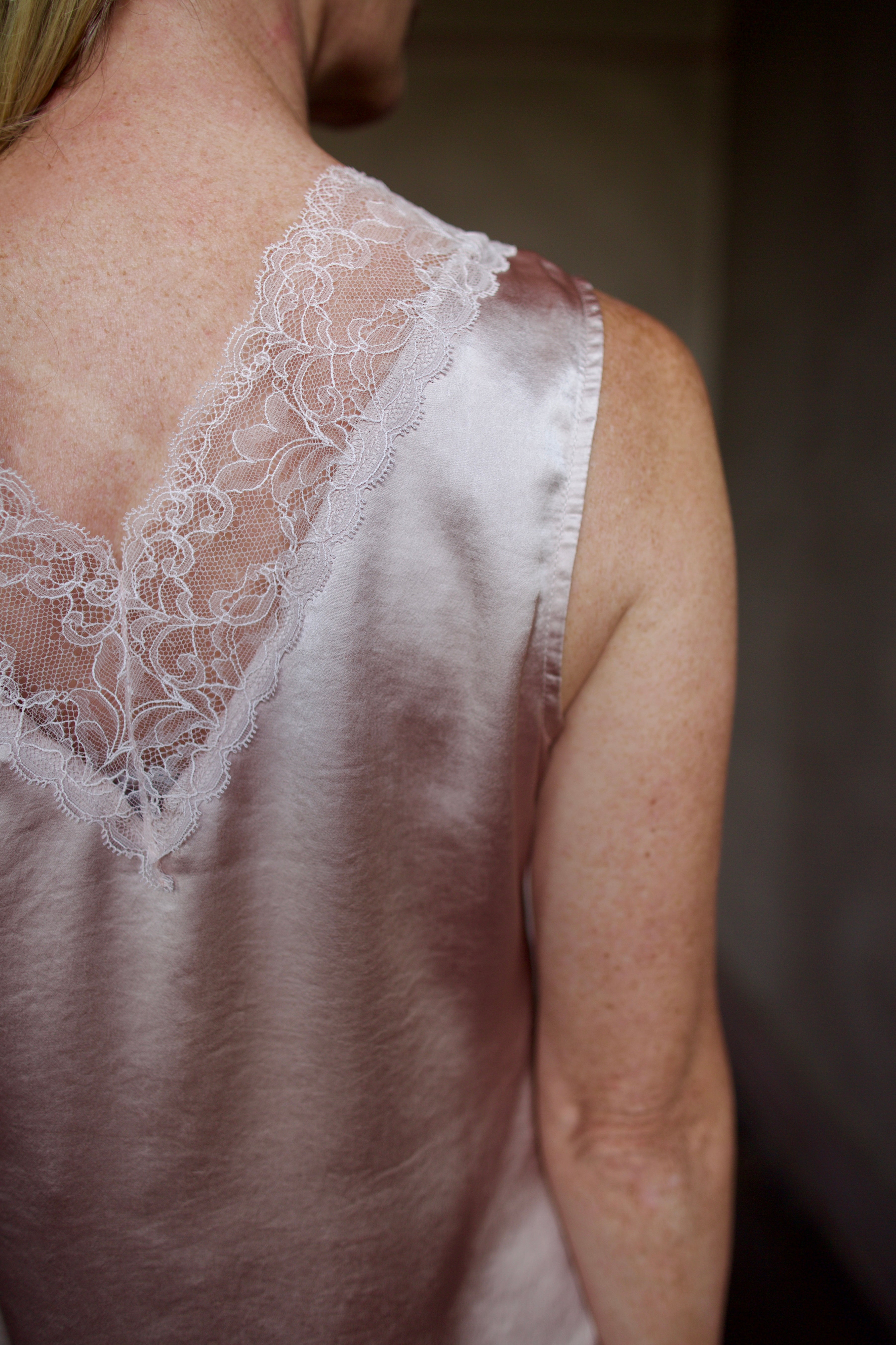 Mature model wearing a bra friendly camisole top with lace detailing at front and back neckline by WE-R4 