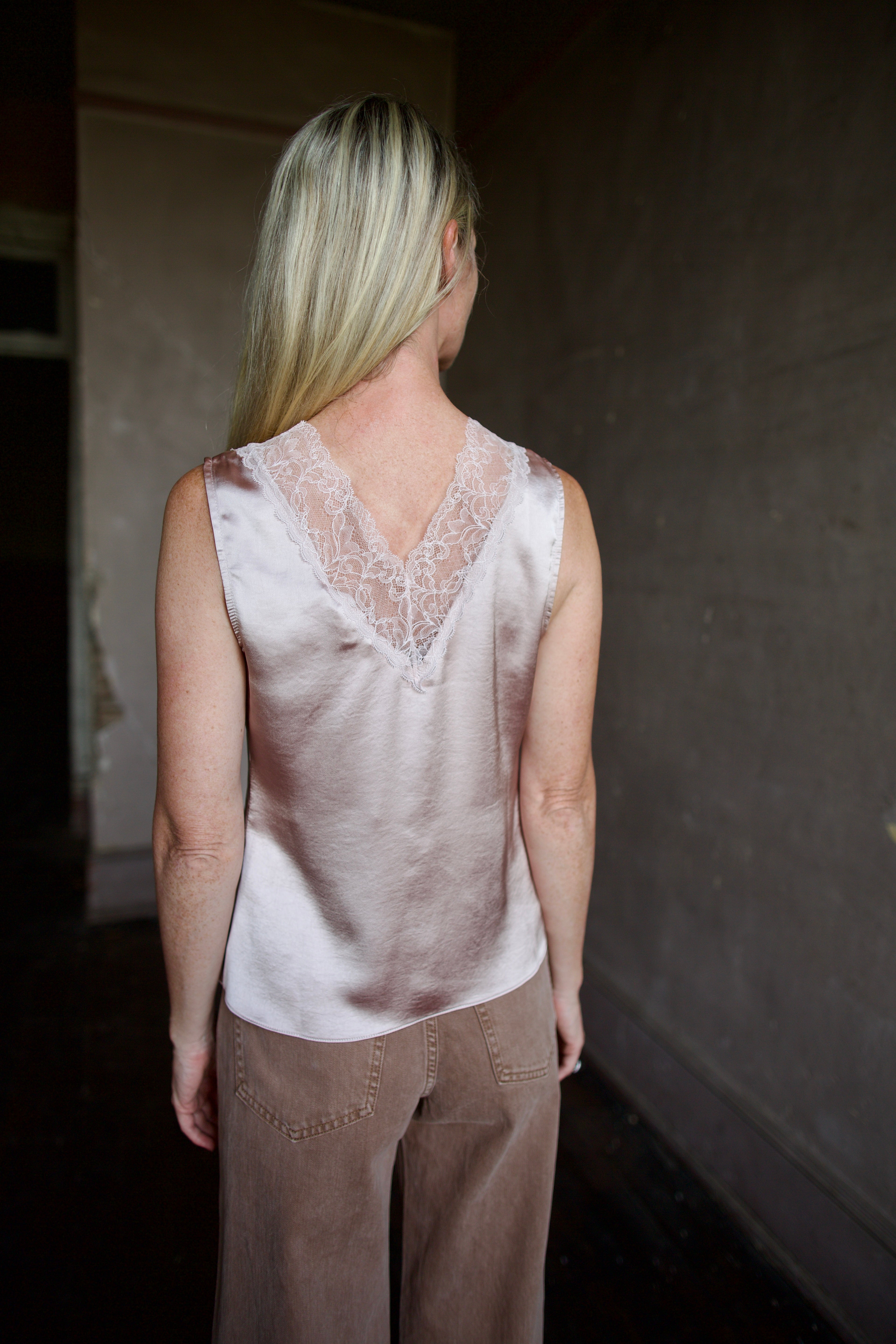 Mature model wearing a bra friendly camisole top with lace detailing at front and back neckline by WE-R4 