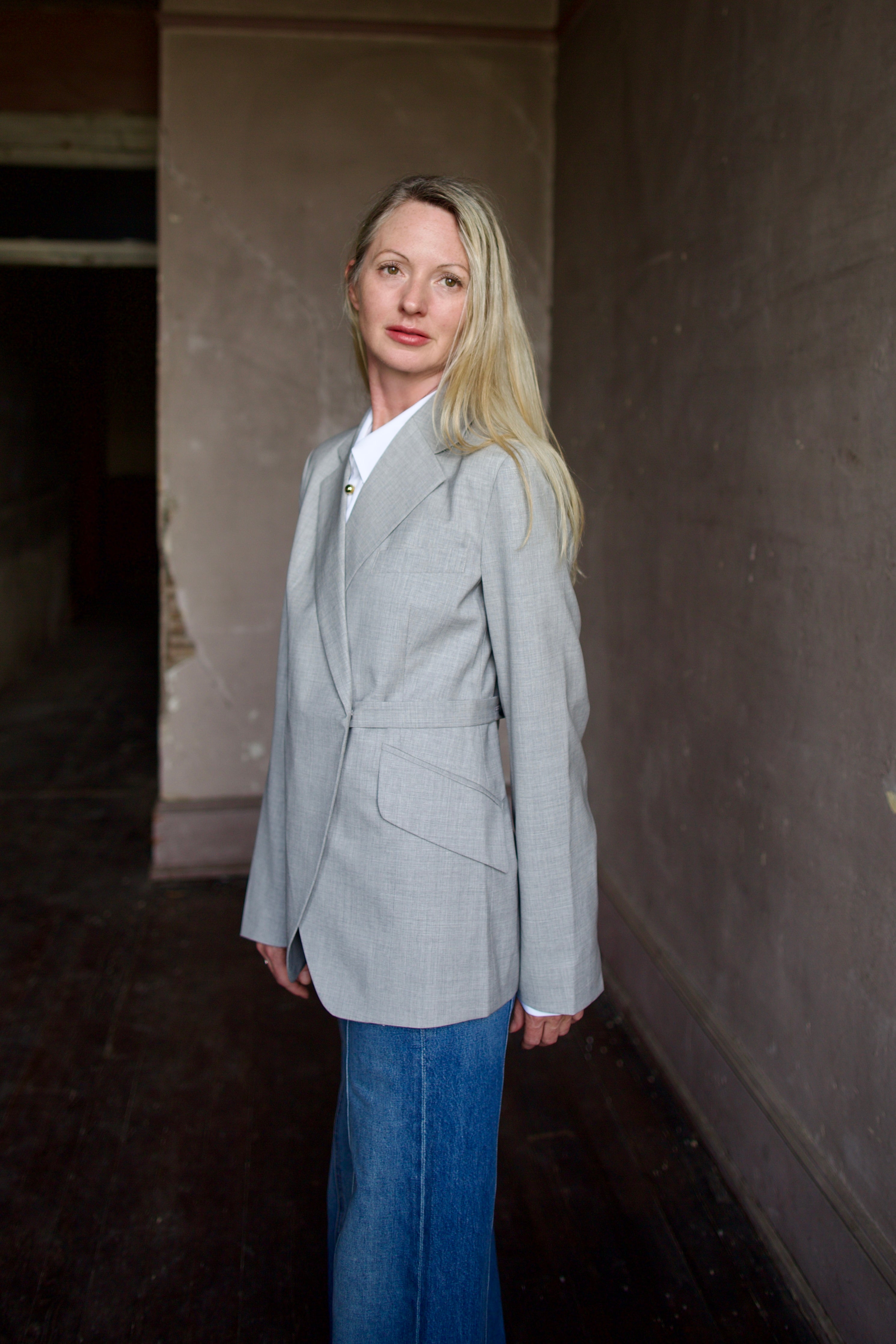 Mature model wearing a WE-AR4 gray wool blazer with luxury detailing and unique modern design