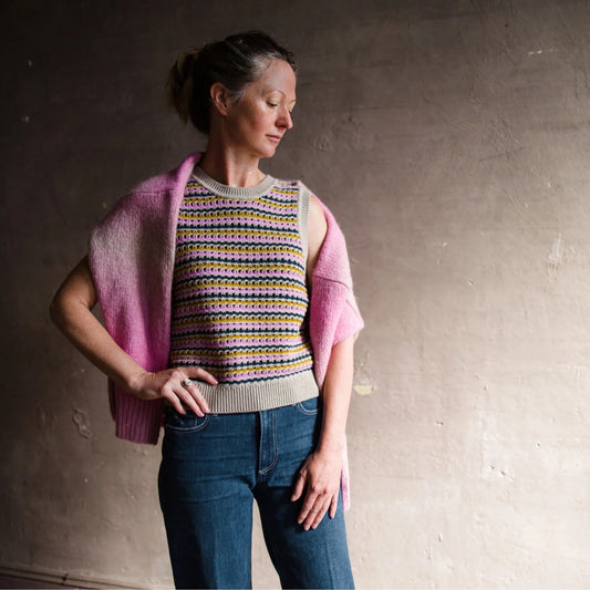 Image featuring a woman wearing the White + Warren sweater tank top with multi-colored stripes in an open mesh stitch.