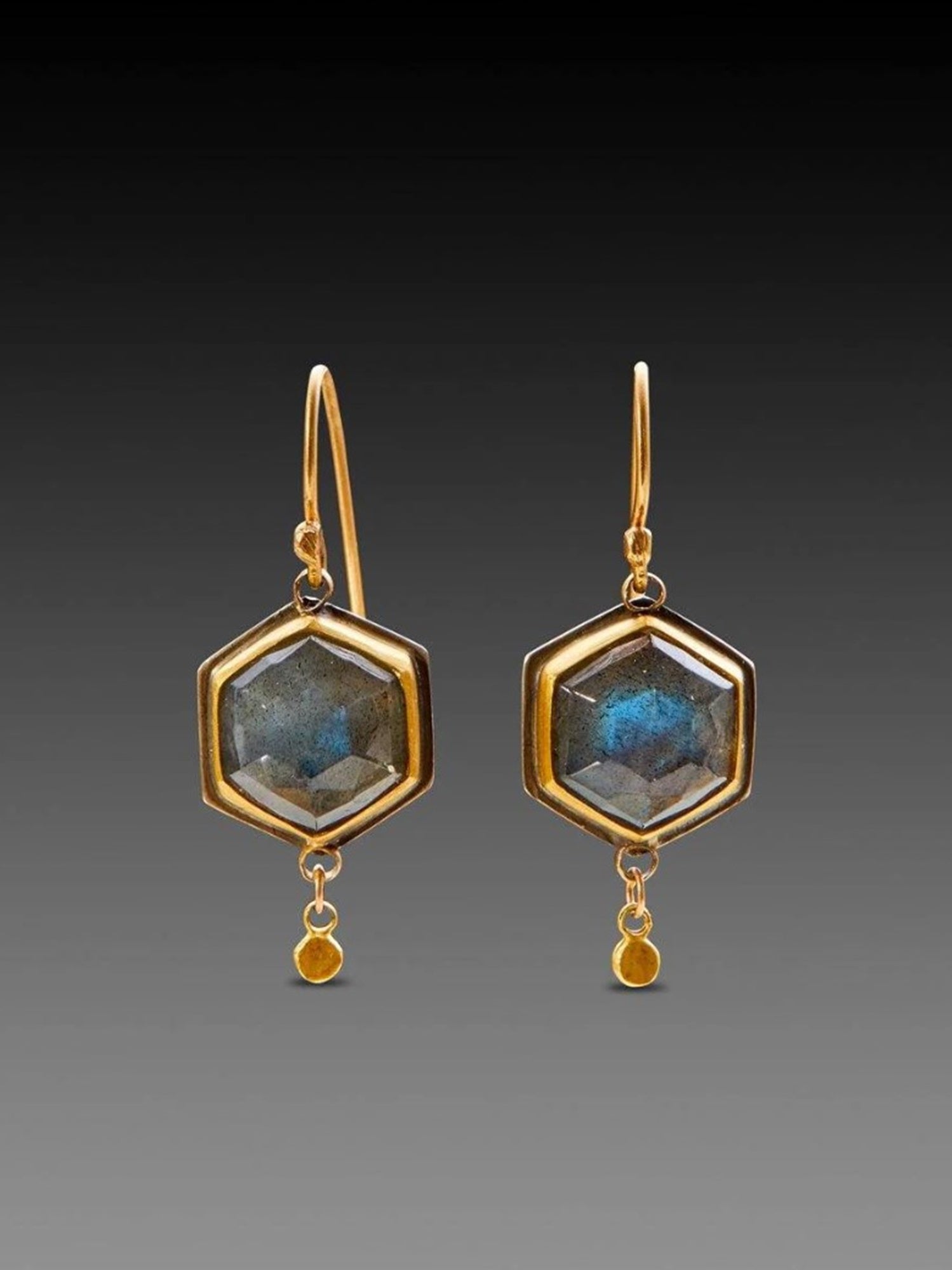 Image of pair of rosecut labradorite hexagon drop earrings with 22kt gold bezel and 18kt gold earwire by American jeweler Ananda Khalsa