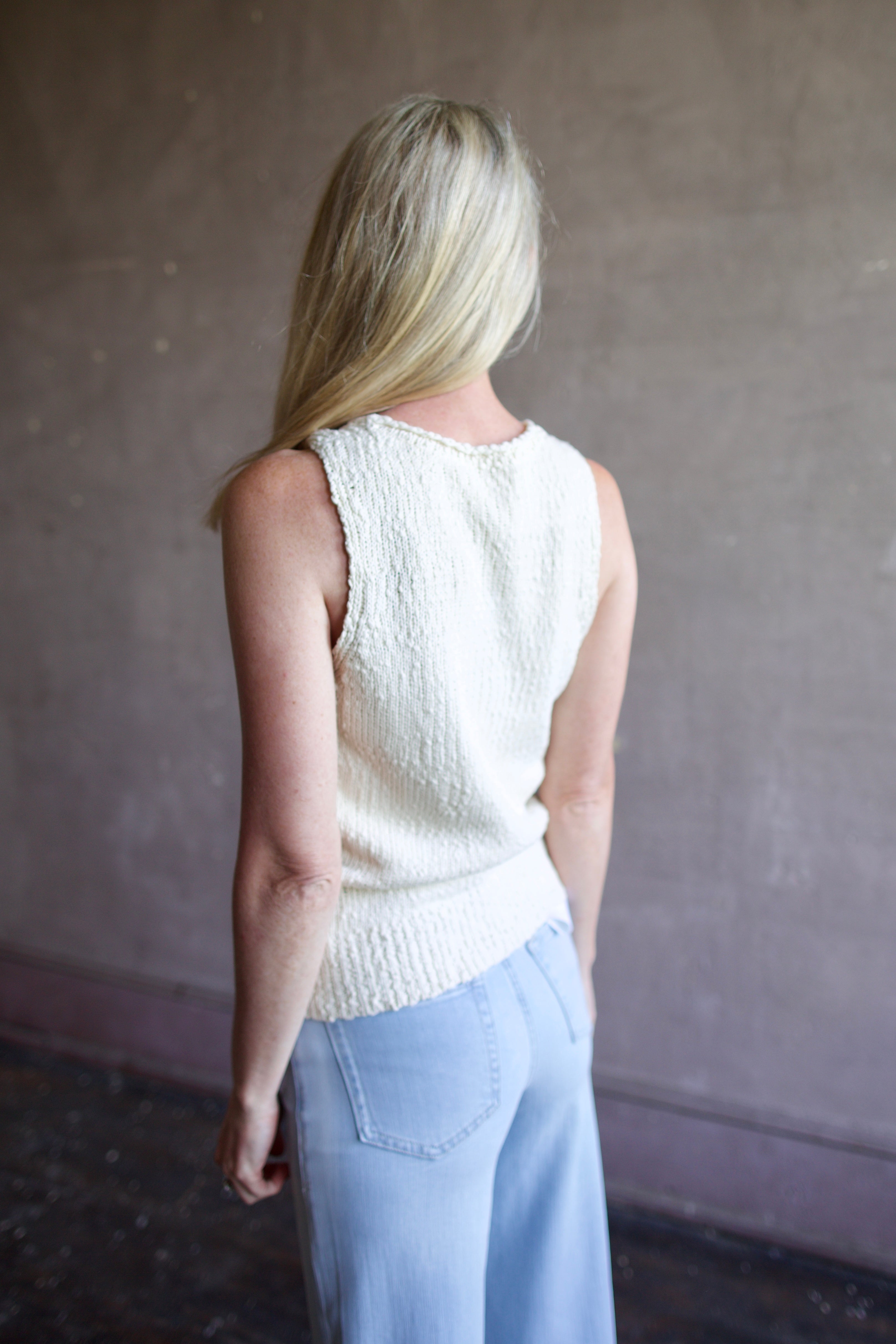 Back image of a woman wearing the Apiece Apart Chiesa Vest