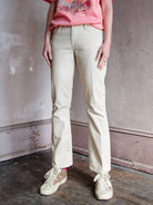 Image featuring a woman wearing le crop mini boot jeans by Frame with a slightly flared leg. They have a raw hem in sand with a white pinstripe. 