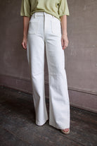 Mature woman wearing Le Jean Parker Soft Barrel Bone White cotton-elastane denim high rise gently curved barrel leg Made in USA quietly sculptural