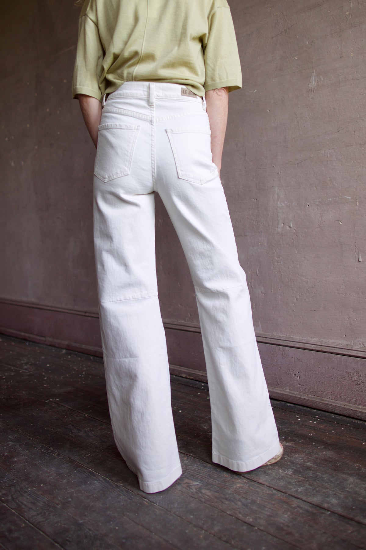 Mature woman wearing Le Jean Parker Soft Barrel Bone White cotton-elastane denim high rise gently curved barrel leg Made in USA quietly sculptural