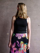 Image featuring a woman wearing the black tanks a lot layering knit tank by Le Superbe with a round neck, sleeveless, and form fitting.