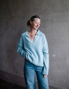 Image featuring a woman wearing the Kerry sweater by Lisa Yang with a v neckline and collar in the softest powder blue brushed cashmere.