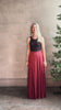 Mature woman reviewing Flowy Maxi A-Line Skirt from TWP rendered in a rich red currant and crafted from a luxurious  silk blend with hidden seam zip closure and tailored waistband