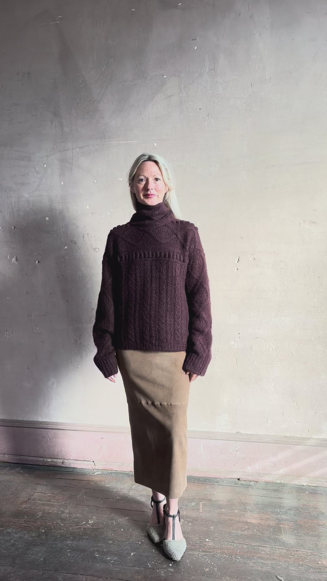 Video reviewing Guest in Residence’s Super Cloud T Neck in Fig cashmere-silk boucle knit with a cable pattern and oversized funnel neck. Jewel-toned, cloud-soft statement warmth