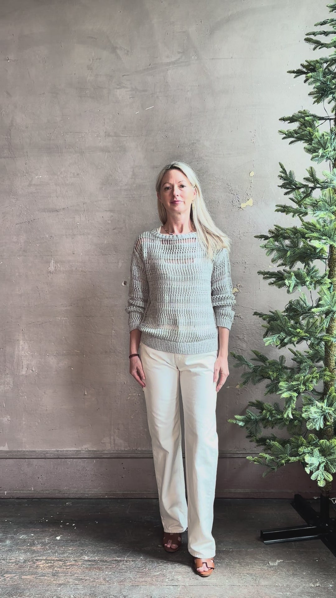 Mature woman reviewing luxury Kent St modern Denim from TWP rendered in a pristine white and crafted from 100% cotton in the USA with a straight leg, high-rise and zipper closure