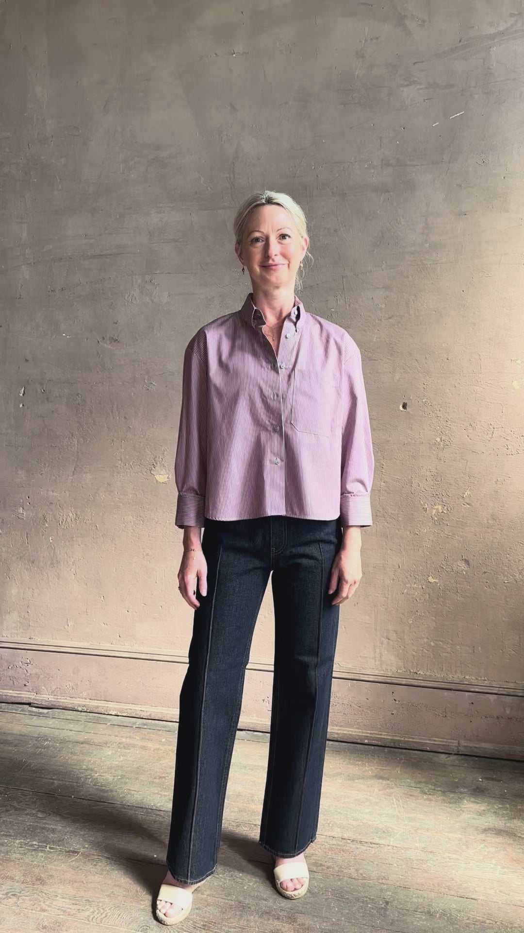 Mature woman reviewing JD blue and white stripe collared button-down shirt by TWP with sequin embellishments