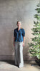 Mature woman reviewing Jess Blouse from Trovata rendered in a classic  Navy blue and crafted from light weight cotton poplin with short sleeves, peter pan collar, v-neck button front with intricate pintucking details at front and back