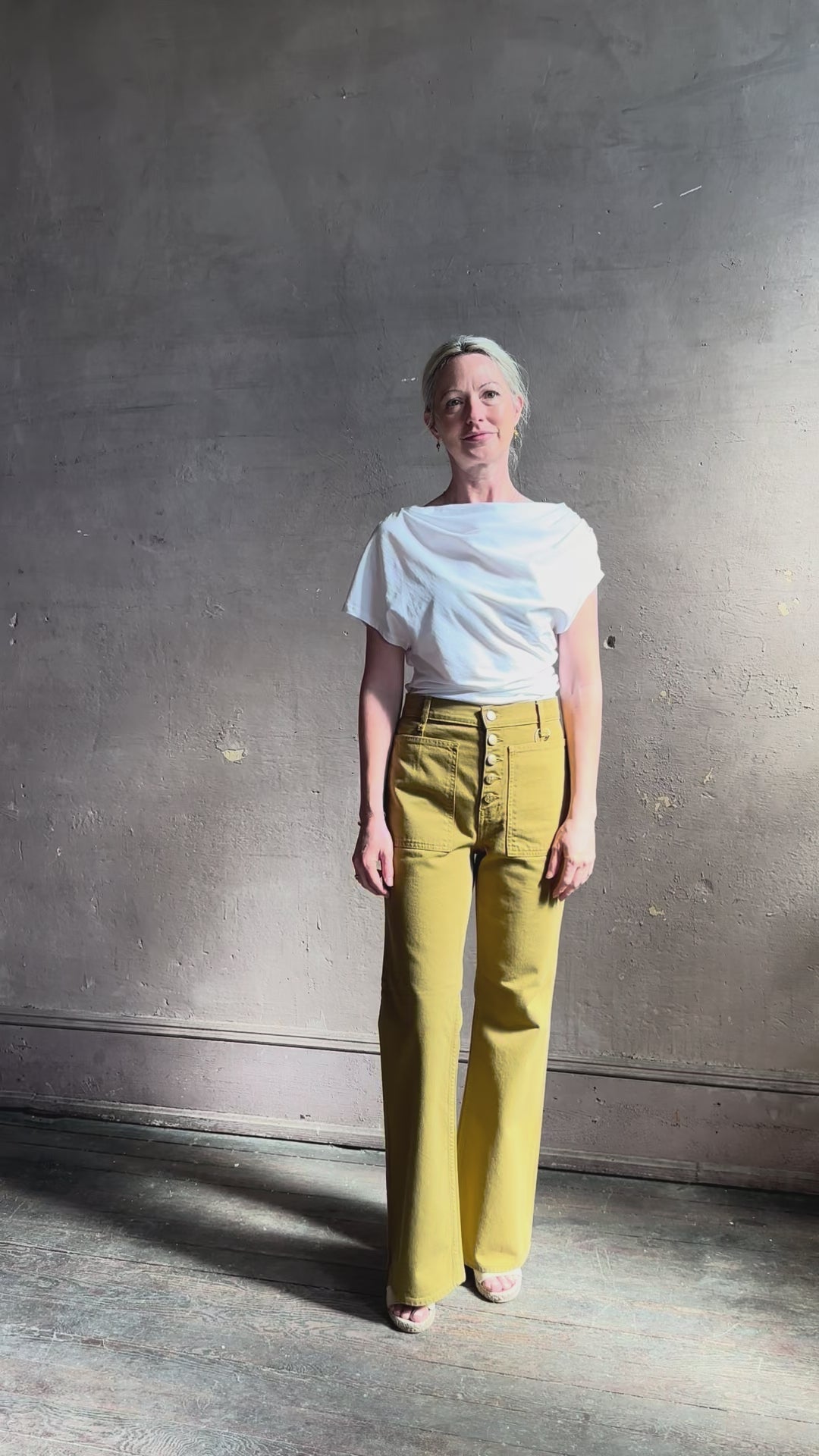 Mature woman reviewing ALC Alice cotton t-shirt with ruched side and shoulder detail that can be worn asymmetrically in bright white 
