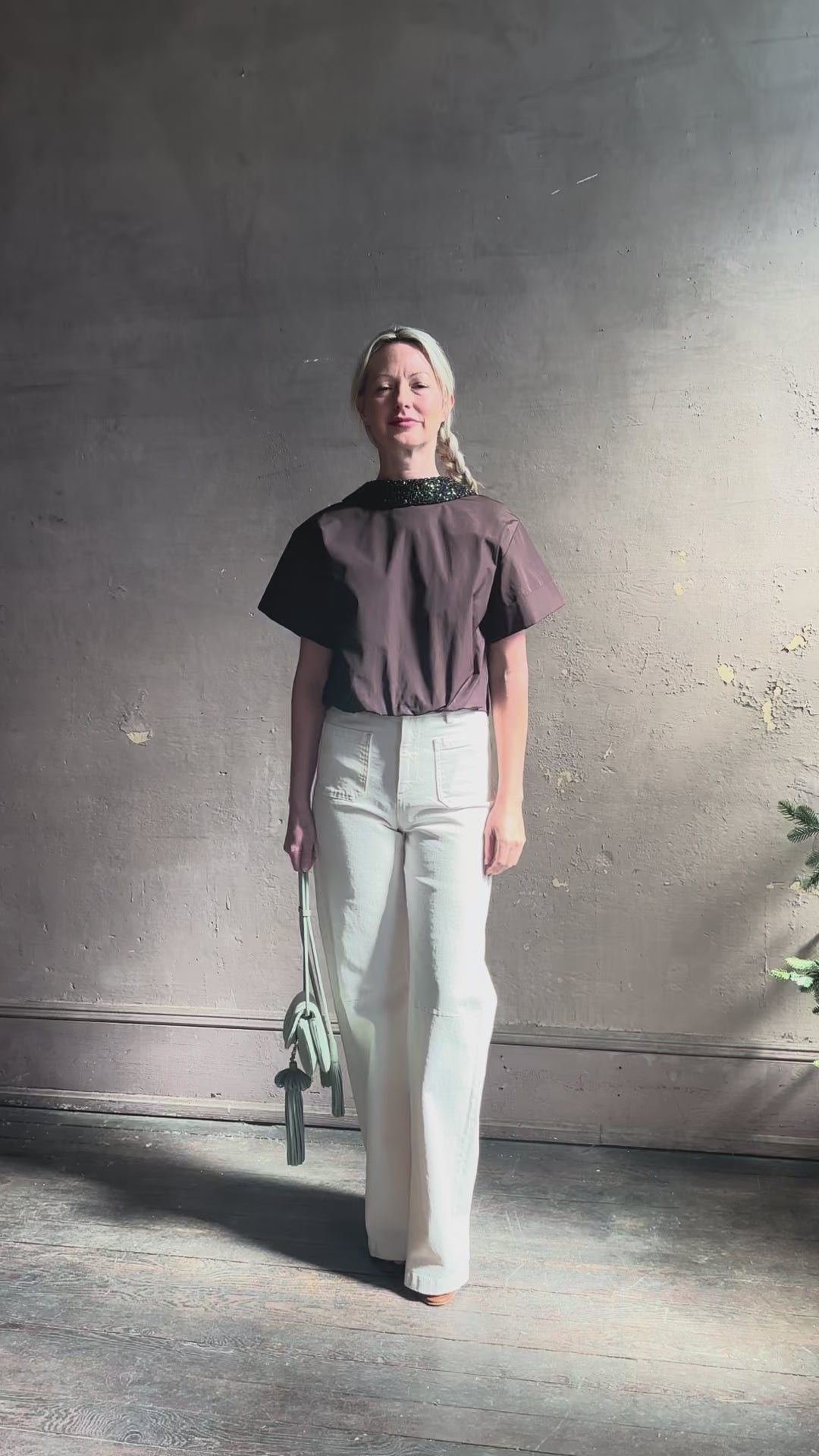 Mature woman reviewing Forever and Always with Crystal Collar Top from TWP women's luxury designer blouse rendered in chocolate brown and crafted from 100% cotton in the USA with crystal collar, short sleeves and reversible