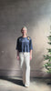 Mature woman reviewing Women's luxury  clothing brand TWP Ex T in premium hammered satin with short sleeves crew neck and a casual front pocket rendered in a beautiful navy blue hue