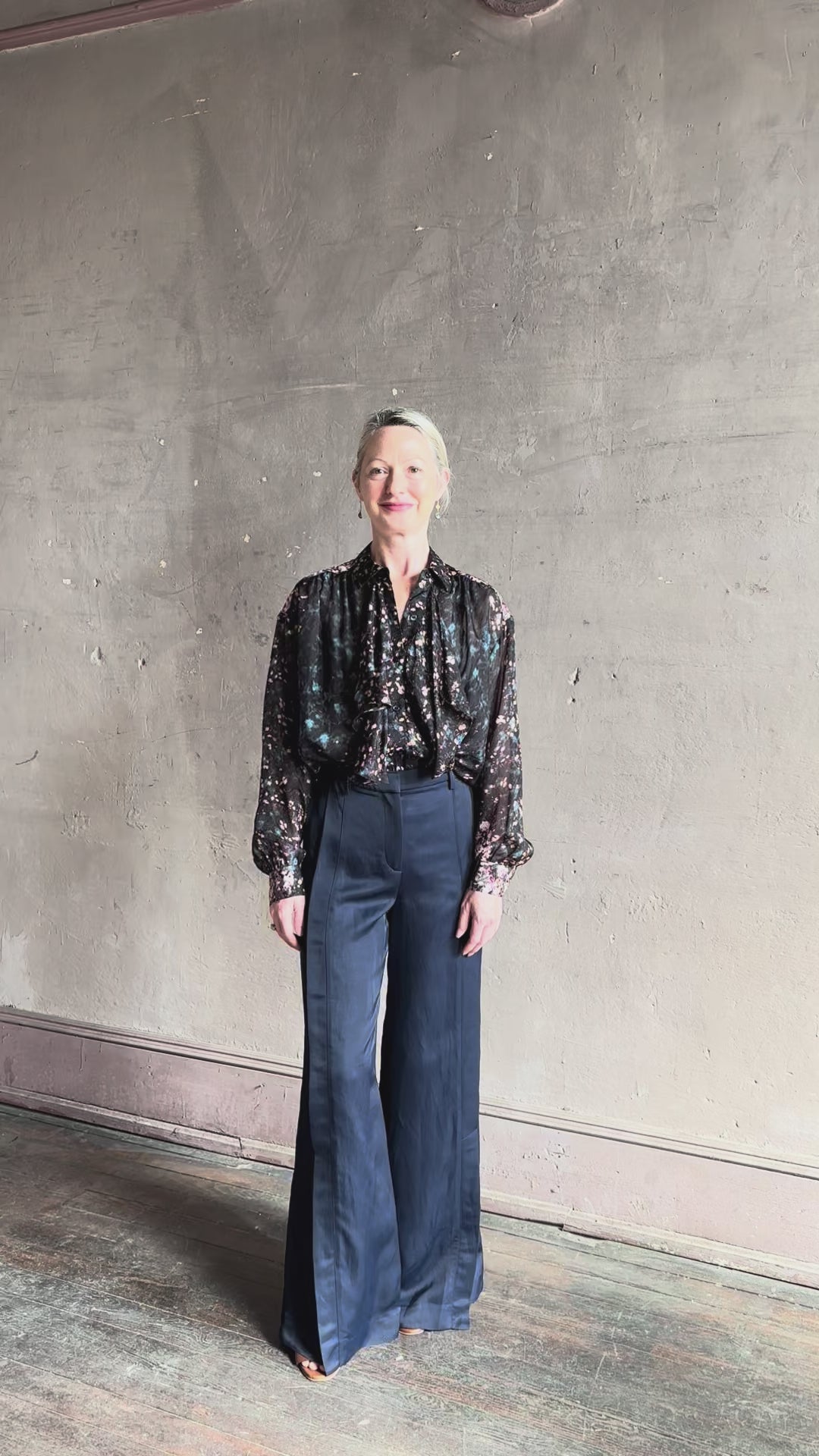 Video reviewing Ulla Johnson long-sleeve black silk blouse subtle floral print collared button front ruffle detail