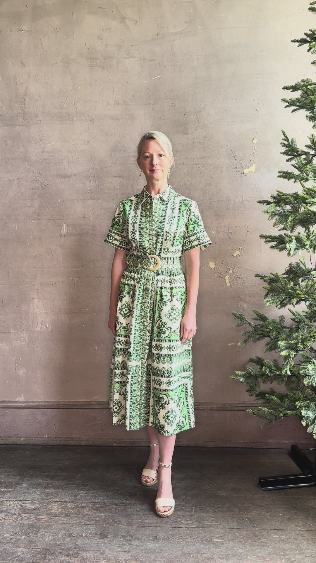 Mature woman reviewing Cara Cara designer Malena cotton poplin shirt dress in a green Hudson Scarf Mint print with short sleeves ad belt