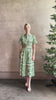 Mature woman reviewing Cara Cara designer Malena cotton poplin shirt dress in a green Hudson Scarf Mint print with short sleeves ad belt