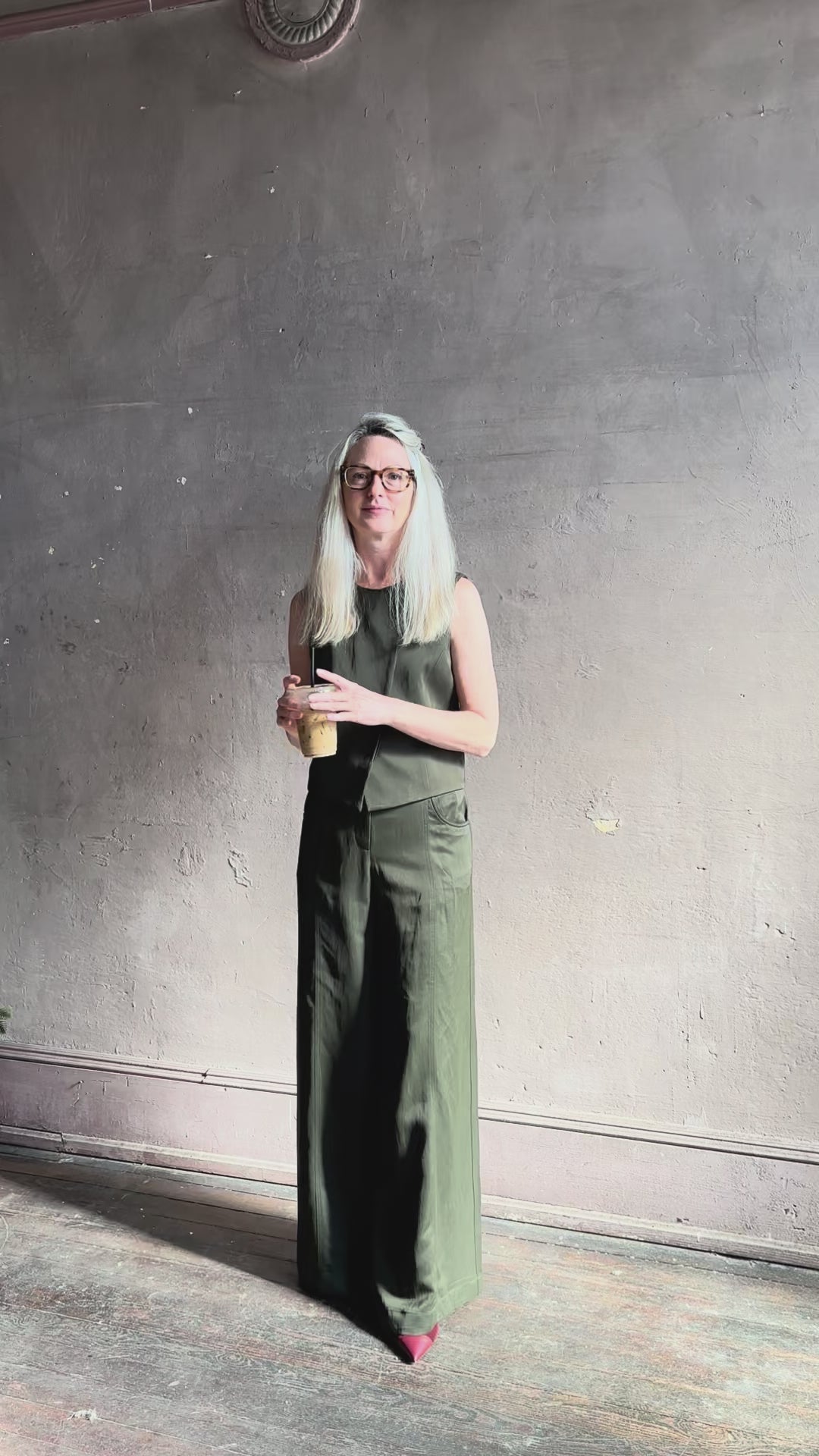 Video reviewing TWP high neck hidden placket vest top with matching pant set in a dark green linen viscose blend fabric