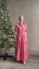 Mature woman reviewing TROVATA Martine button down cotton shirt dress in Rosdo rose with feminine ruffle sleeves and tiered skirt