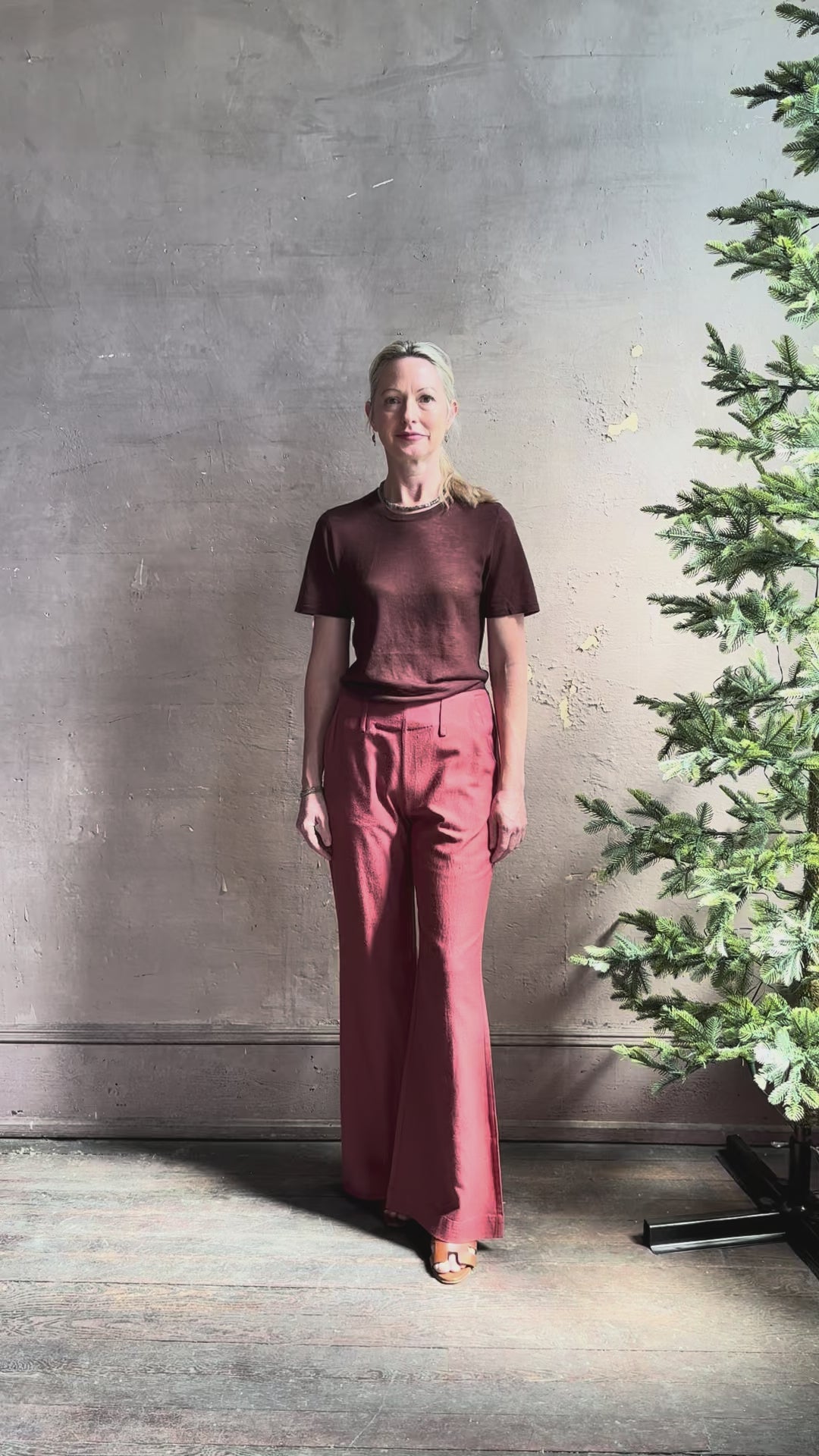 Woman reviewing sophisticated ALIX OF BOHEMIA Charlie Red Ochre Silk mid-rise Pant with front and back pockets, belt loops, flat front and full length straight leg