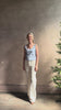 Mature woman reviewing luxury cashmere knitwear Tanya Taylor Rory Cashmere Tank top in Pale Blue with a feminine scoop neckline