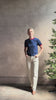 Mature woman reviewing women's designer cashmere Airy short sleeve Ringer Tee from Guest in Residence rendered in a navy body with carmine ringer detailing and crafted from 100% lightweight cashmere with a crew neckline