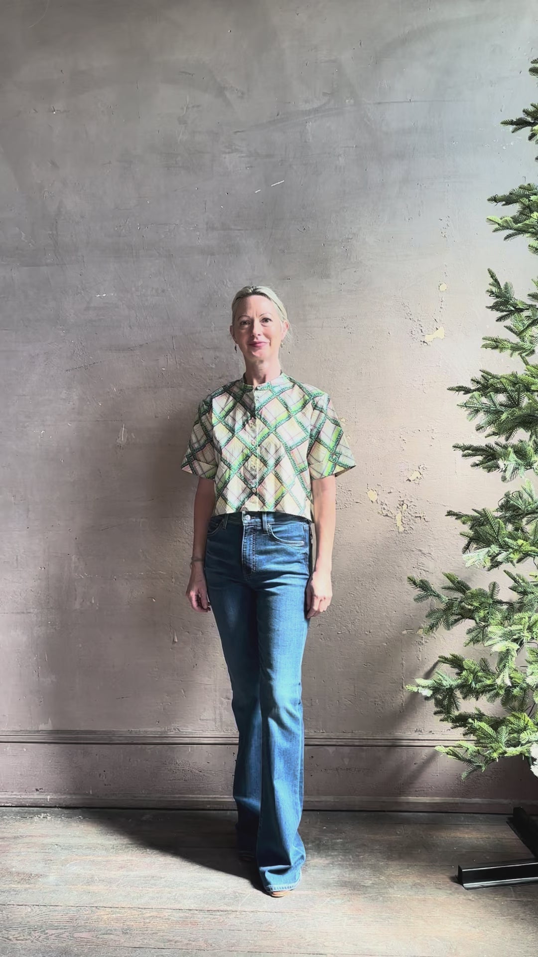 Mature woman reviewing the Saloni Jude-B short sleeve plaid button up crop top crafted in cotton with happy diagonal green plaid expertly aligned pattern