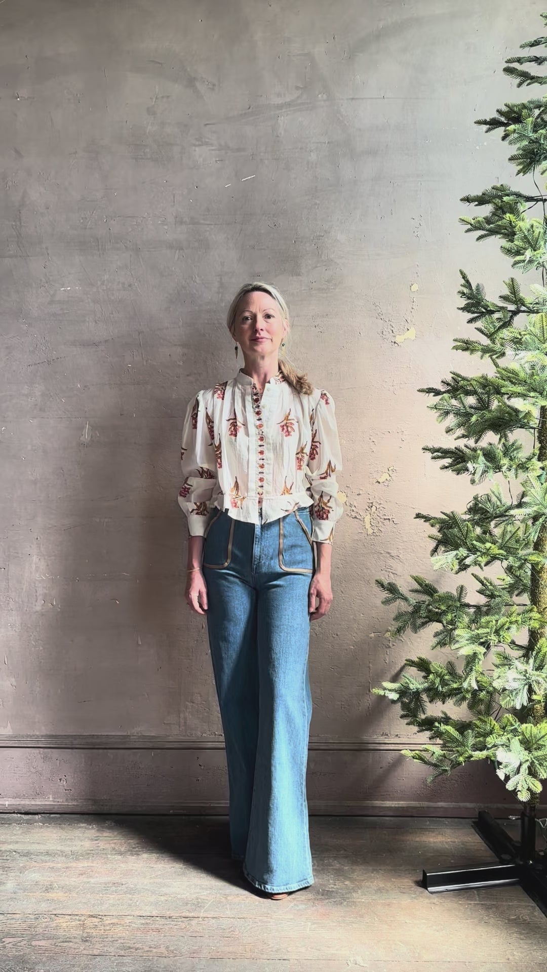 Mature woman reviewing Alix of Bohemia Ryland Persimmon Flower Shirt with beautiful pin tucking and gathered waist detail at back, long sleeves, mandarin collar, and cropped top