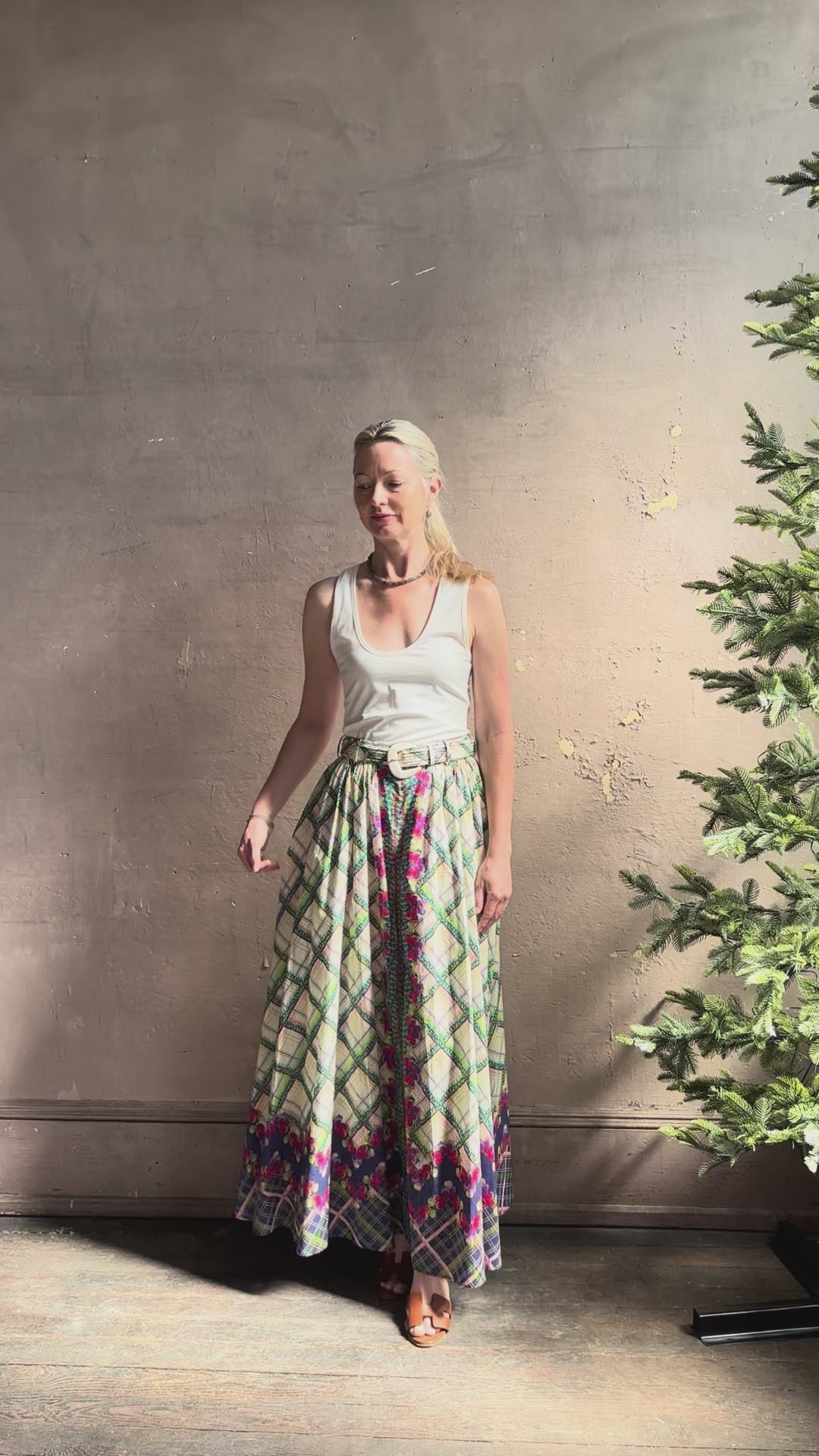 Mature woman reviewing Saloni Judi maxi plaid skirt with matching belt. This cotton A-line skirt is trimmed in pansies down front and bottom with front opening for additional ventilation
