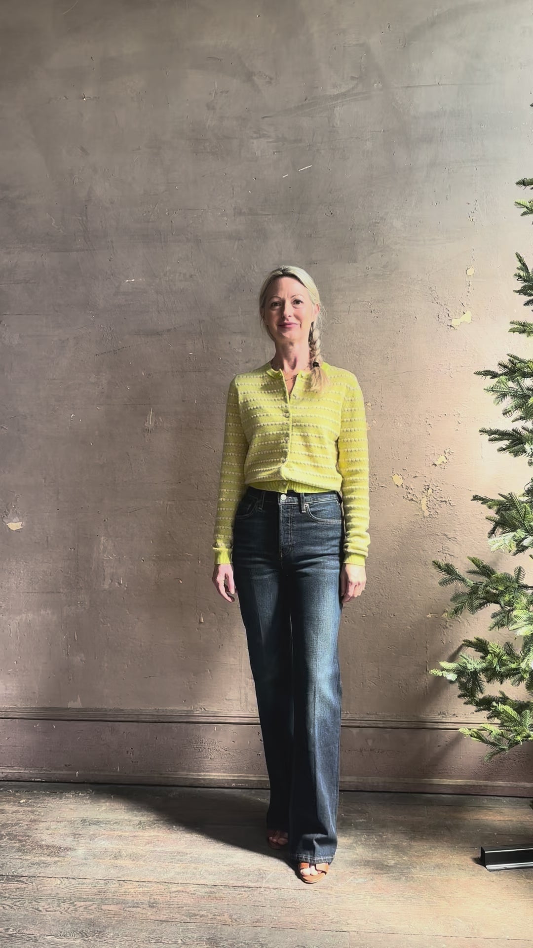 Mature woman reviewing REDONE 70s Bootcut Denim in a dark blue wash with comfort stretch zip closure finished hem and 10.75" rise