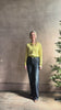 Mature woman reviewing REDONE 70s Bootcut Denim in a dark blue wash with comfort stretch zip closure finished hem and 10.75" rise