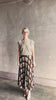 Video reviewing designer Cara Cara brown, cream, and green plaid patterned pleated otta maxi skirt