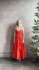 Mature woman reviewing  Michelyn maxi designer Dress from Proenza Schouler rendered in a striking orange and crafted from a refined cotton blend with adjustable spaghetti straps, v-neck, pockets, hidden zipper closure and modern ruching details