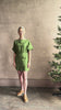 Mature woman reviewing the effortlessly  Sigrun Mini summer Dress from Apiece Apart rendered in 100% linen with a boat neck, loose half sleeves and blouson style