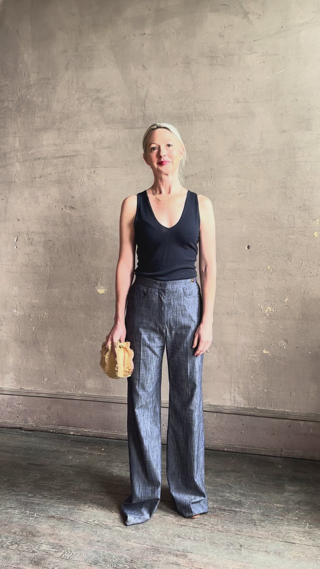 Mature woman reviewing Italian designer Tonne trouser from Callas rendered in a dark indigo and crafted from a viscose, polyester, and linen blend with beautiful fluid draping and effortless versitility similar to denim